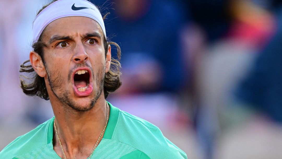 Italy's Lorenzo Musetti celebrates after winning against Britain's Cameron Norrie at the end of their men's singles match on day six of the Roland-Garros Open tennis tournament at the Court Simonne-Mathieu in Paris on June 2, 2023. (Photo by Emmanuel DUNAND / AFP)