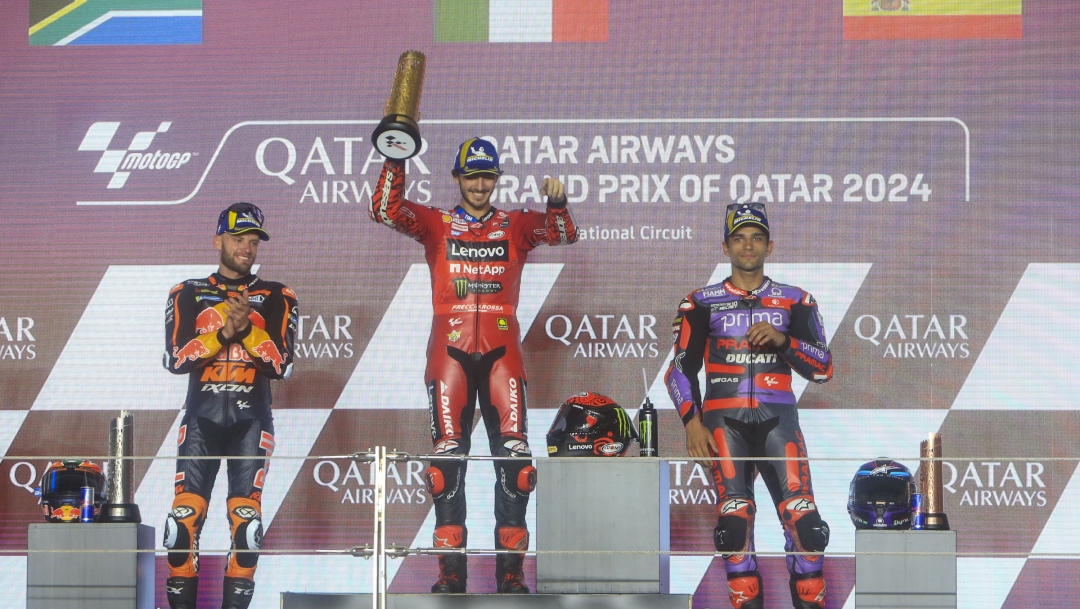 Race winner Italian rider Francesco Bagnaia of the Ducati Lenovo Team, center, second placed South African rider Brad Binder of the Red Bull KTM Factory Racing, left, and third placed Spain's rider Jorge Martin of the Prima Pramac Racing celebrate on the podium after the MotoGP race of the Qatar Motorcycle Grand Prix, at the Lusail International Circuit in Doha, Qatar, Sunday, March 10, 2024. (AP Photo/Hussein Sayed)