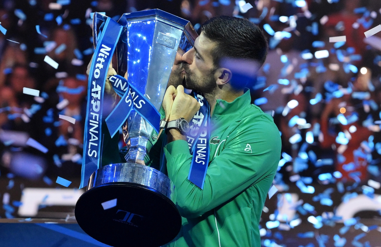 Novak Djokovic of Serbia celebrates with the trophy after winning the final against Jannik Sinner of Italy at the Nitto ATP Finals tennis tournament in Turin, Italy, 19 November 2023.  ANSA/ALESSANDRO DI MARCO