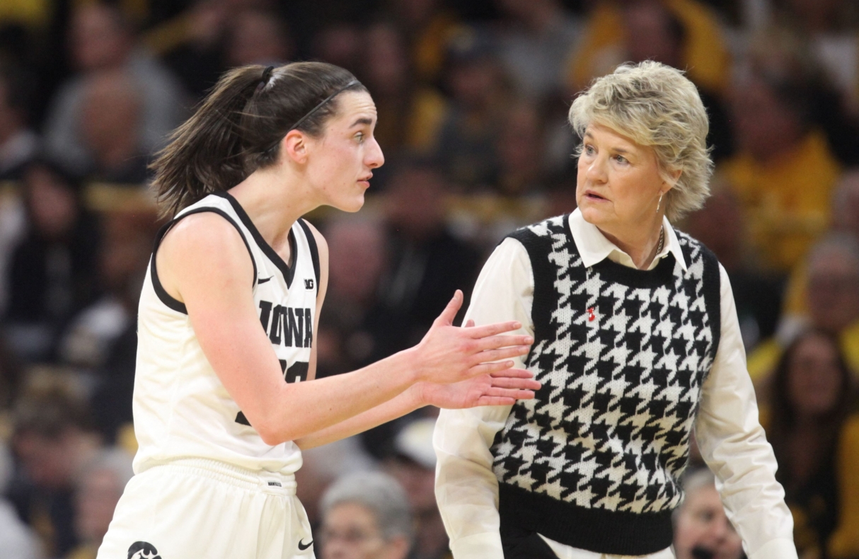 vIOWA CITY, IOWA- FEBRUARY 15: Guard Caitlin Clark #22 of the Iowa Hawkeyes talks with head coach Lisa Bluder during the first half against the Michigan Wolverines at Carver-Hawkeye Arena on February 15, 2024 in Iowa City, Iowa.   Matthew Holst/Getty Images/AFP (Photo by Matthew Holst / GETTY IMAGES NORTH AMERICA / Getty Images via AFP)