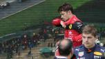 Ferrari driver Charles Leclerc, top, of Monaco, walks past next to Red Bull driver Max Verstappen of the Netherlands at the end of the Emilia Romagna Formula One Grand Prix, at the Enzo and Dino Ferrari racetrack, in Imola, Italy, Sunday, April 24, 2022. (AP Photo/Luca Bruno)