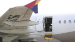 An Asiana Airlines plane is parked as one of the plane's doors suddenly opened at Daegu International Airport in Daegu, South Korea, Friday, May 26, 2023. A passenger opened a door on an Asiana Airlines flight that later landed safely at a South Korean airport Friday, airline and government officials said. (Yun Kwan-shick/Yonhap via AP)