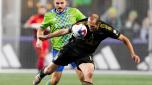 Seattle Sounders forward Jordan Morris, left, and Los Angeles FC defender Giorgio Chiellini, right, vie for the ball during the first half of an MLS conference semifinal playoff soccer match Sunday, Nov. 26, 2023, in Seattle. (AP Photo/Lindsey Wasson)