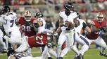 Baltimore Ravens' Lamar Jackson (8) eludes a sack attempt by San Francisco 49ers' Ji'Ayir Brown (27) during an NFL football game in Santa Clara, Calif., Monday, Dec. 25, 2023. (Scott Strazzante/San Francisco Chronicle via AP)