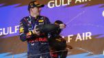 First placed Red Bull Racing's Dutch driver Max Verstappen (L) and second placed Red Bull Racing's Mexican driver Sergio Perez celebrate during the podium ceremony of the Bahrain Formula One Grand Prix at the Bahrain International Circuit in Sakhir on March 2, 2024. (Photo by Giuseppe CACACE / AFP)