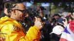 Mercedes driver Lewis Hamilton of Britain gestures to fans as he arrives at the Albert Park circuit ahead of the Australian Formula One Grand Prix in Melbourne, Australia, Thursday, March 21, 2024. (AP Photo/Asanka Brendon Ratnayake)