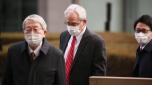 Greg Kelly, center, former executive of Japanese automaker Nissan, arrives at the Tokyo District Court in Tokyo Thursday, March 3, 2022. The court gave Kelly who is charged with underreporting his boss Carlos Ghosn?s pay, a 6-month suspended sentence. (Zhang Xiaoyu/Pool Photo via AP)