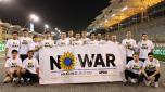 BAHRAIN, BAHRAIN - MARCH 09: F1 drivers pose with a banner promoting peace and sympathy with Ukraine prior to F1 Testing at Bahrain International Circuit on March 09, 2022 in Bahrain, Bahrain. (Photo by Mark Thompson/Getty Images)