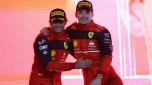 Winner Ferrari's Monegasque driver Charles Leclerc (L) and second place Ferrari's Spanish driver Carlos Sainz Jr celebrate on the podium after the Bahrain Formula One Grand Prix at the Bahrain International Circuit in the city of Sakhir on March 20, 2022. (Photo by Giuseppe CACACE / AFP)