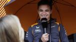 McLaren driver Lando Norris of Britain speaks with a journalist as he arrives in the paddock at the Dino and Enzo Ferrari racetrack, in Imola, Italy, Thursday, April 21, 2022. Italy's Emila Romagna Formula One Grand Prix will take place on Sunday. (AP Photo/Luca Bruno)