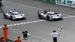 France's Benoit Treluyer of Audi R18 e-tron quattro crosses the finish line to win ahead of Audi R18 e-tron quattro driven by Denmark's Tom Kristensen, during the 82nd 24-hour Le Mans endurance race, in Le Mans, western France, Sunday, June 15, 2014. (AP Photo/Bob Edme)