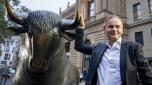 CEO of Porsche car maker Oliver Blume touches the bull statue at the start of Porsche's market listing at the stock market in Frankfurt, Germany, Thursday, Sept. 29, 2022. (AP Photo/Michael Probst)