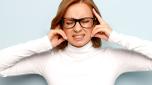 Annoyed business woman in glasses shuts ears, close eyes, trying keep calm and take control over emotions, unwilling hear, can't concentrate, isolated. Bothering noise, earache, stressful environment.
