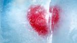 Red heart frozen in ice with a big crack, a symbol of love or betrayal or separation