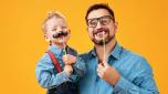 happy father's day! funny dad and son with mustache fooling around on colored yellow background