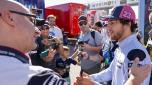 epa10287728 Moto GP rider Enea Bastianini (R) of Italy chats with supporters ahead of a training session at Ricardo Tormo Circuit in Cheste, Valencia, 05 November 2022. Comunidad Valenciana Motorciclyng Grand Prix, the last Grand Prix of the season, is to take place on 06 November 2022.  EPA/BIEL ALINO