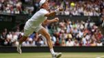 LONDON, ENGLAND - JULY 05: Jannik Sinner of Italy plays a forehand against Novak Djokovic of Serbia during their Men's Singles Quarter Final match on day nine of The Championships Wimbledon 2022 at All England Lawn Tennis and Croquet Club on July 05, 2022 in London, England. (Photo by Julian Finney/Getty Images)