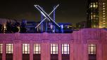 Workers install lighting on an "X" sign atop the company headquarters, formerly known as Twitter, in downtown San Francisco, on Friday, July 28, 2023. San Francisco has launched an investigation into the sign as city officials say replacing letters or symbols on buildings, or erecting a sign on top of one, requires a permit. (AP Photo/Noah Berger)