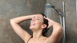 Happy woman showering and singing
