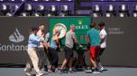 CANCUN, MEXICO - OCTOBER 28: Workers carry a Rolex court clock into place as they prepare the court prior to the GNP Seguros WTA Finals Cancun 2023 as part of the Hologic WTA Tour on October 27, 2023 in Cancun, Mexico.  (Photo by Clive Brunskill/Getty Images)