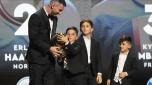 Inter Miami's and Argentina's national team player Lionel Messi celebrates with his children after receiving the 2023 Ballon d'Or trophy during the 67th Ballon d'Or (Golden Ball) award ceremony at Theatre du Chatelet in Paris, France, Monday, Oct. 30, 2023. (AP Photo/Michel Euler)