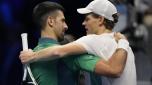 Italy's Jannik Sinner, right, embraces Serbia's Novak Djokovic at the end of the singles tennis match of the ATP World Tour Finals at the Pala Alpitour, in Turin, Italy, Tuesday, Nov. 14, 2023. (AP Photo/Antonio Calanni)
