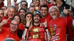 Ducati Italian rider Francesco Bagnaia (C) and his partner Domizia Castagnini (CL) celebrate with the team after winning the MotoGP Valencia Grand Prix at the Ricardo Tormo racetrack in Cheste, on November 26, 2023. Italy's Francesco Bagnaia enjoyed a dream day as he retained his MotoGP world title and crowned it with victory in the final race of the season in Valencia today. The 26-year-old Ducati rider had been assured of the championship when his sole rival Jorge Martin crashed early in the race. (Photo by JAVIER SORIANO / AFP)