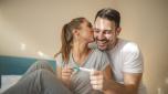 We become parents. Shot of a couple feeling happy after taking a home pregnancy test.  I'm pregnant! Happy young couple with pregnancy test. Joyful couple with positive pregnancy shown in the test device