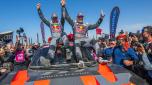 TOPSHOT - Team Audi Sport's Spanish driver Carlos Sainz (C,R) and his Spanish co-driver Lucas Cruz of (C,L) celebrate on their car after crossing the finish line of stage 12  of the Dakar rally 2024 from Yanbu to Yanbu, on January 19, 2024, at the end. Veteran Spanish driver Carlos Sainz won on January 19, 2024 the gruelling Dakar Rally for a fourth time on Friday, becoming at 61 the oldest winner of the race. (Photo by PATRICK HERTZOG / AFP)