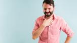 Suffering from a sore throat isolated against a background. Latin man with a reflux because of a heavy meal or dinner