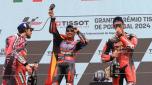 Ducati Spanish rider Jorge Martin (C) celebrates on the podium with second placed Ducati Italian rider Enea Bastianini (L) and third placed KTM Spanish rider Pedro Acosta after winning the MotoGP race of the Portuguese Grand Prix at the Algarve International Circuit in Portimao on March 24, 2024. (Photo by PATRICIA DE MELO MOREIRA / AFP)