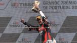 Kalex Spanish rider Aron Canet celebrates on the podium after winning the Moto2 race of the Portuguese Grand Prix at the Algarve International Circuit in Portimao on March 24, 2024. (Photo by PATRICIA DE MELO MOREIRA / AFP)