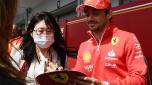 Ferrari's Monegasque driver Charles Leclerc (R) signs an autograph to a fan in the paddock  preparing for the April 7 Formula One Japanese Grand Prix race at the Suzuka circuit in Suzuka, Mie prefecture on April 4, 2024. (Photo by Toshifumi KITAMURA / AFP)