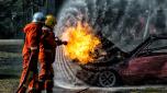 Firefighter training, Fireman annual training fire fighting hosing water to extinguish a fire over the accident car  on the wayside road