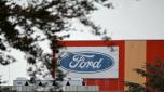 (FILES) The logo of US car manufacturer Ford is pictured on the facade of the Ford plant in Cologne, western Germany, on October 29, 2024, on the sidelines of a warning strike called by metalworkers' union IG Metall. US car manufacturer Ford on November 20, 2024 announced plans for 4,000 further job cuts in Europe, mostly in in the UK and Germany, in the latest blow to the continent's beleaguered car industry. (Photo by INA FASSBENDER / AFP)