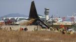 Firefighters and rescue team members work at Muan International Airport in Muan, South Korea, Sunday, Dec. 29, 2024. (Cho Nam-soo/Yonhap via AP)