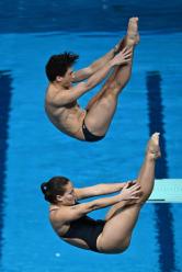 Brazil's Anna Santos and Chiara Pellacani compete in the final of the mixed 3m springboard synchro diving event during the 2024 World Aquatics Championships at Hamad Aquatics Centre in Doha on February 10, 2024. (Photo by MANAN VATSYAYANA / AFP)