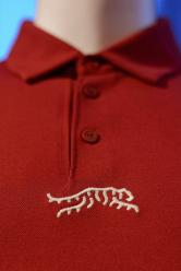 Merchandise from Tiger Woods' new clothing line, called Sun Day Red, is displayed during a news conference ahead of the Genesis Open golf tournament, Monday, Feb. 12, 2024, in the Pacific Palisades area of Los Angeles. (AP Photo/Eric Thayer)
