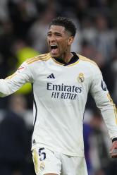 Real Madrid's Jude Bellingham celebrates after scoring his side's third goal during the Spanish La Liga soccer match between Real Madrid and Barcelona at the Santiago Bernabeu stadium in Madrid, Spain, Sunday, April 21, 2024. (AP Photo/Manu Fernandez)