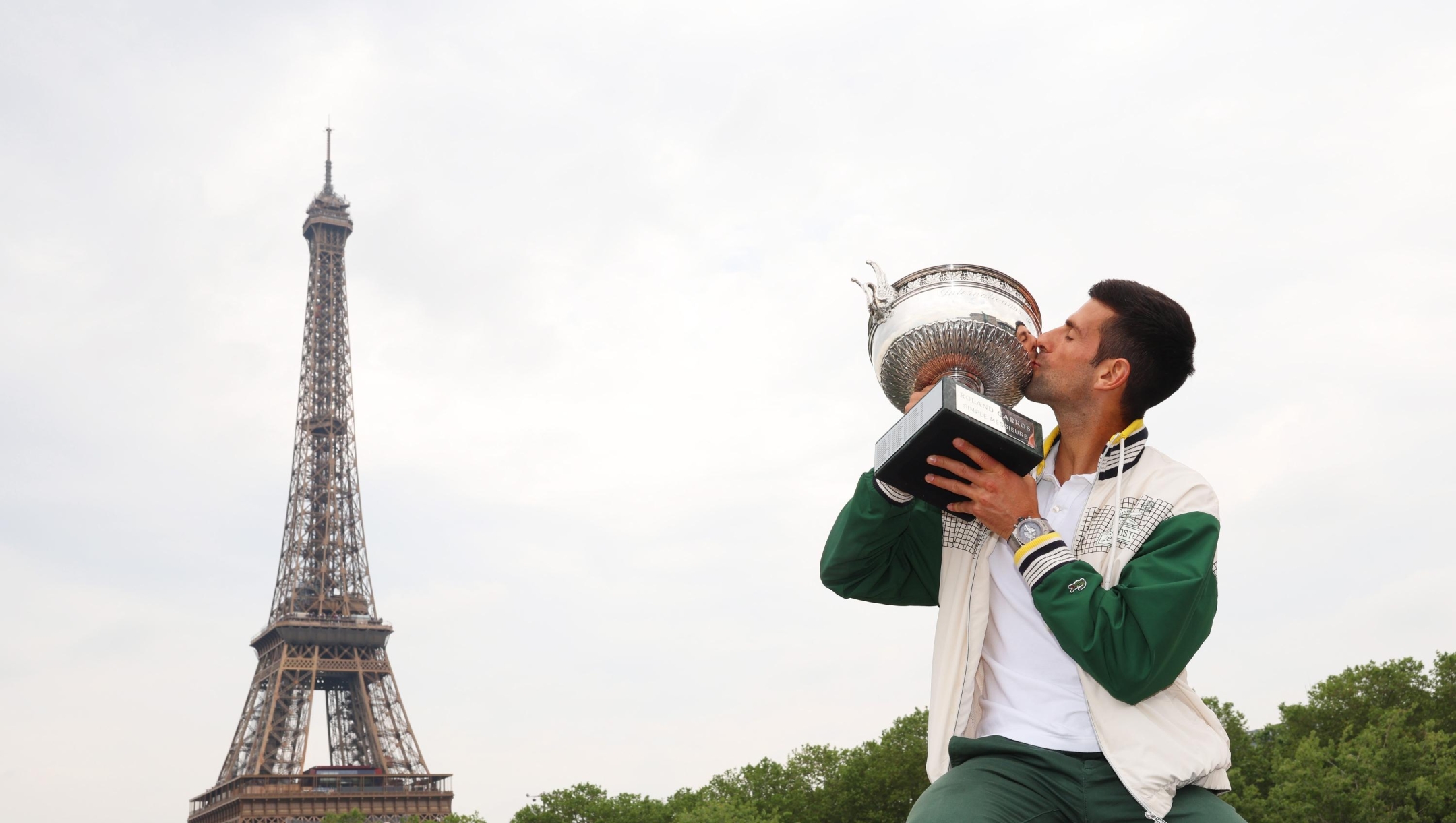 PARIS, FRANCE - JUNE 12: Novak Djokovic of Serbia kisses The Musketeers? Cup after winning his 23rd grand slam trophy on the Bir-Hakeim bridge after winning the Men's Singles Title in the 2023 French Open on June 12, 2023 in Paris, France. (Photo by Clive Brunskill/Getty Images) *** BESTPIX ***