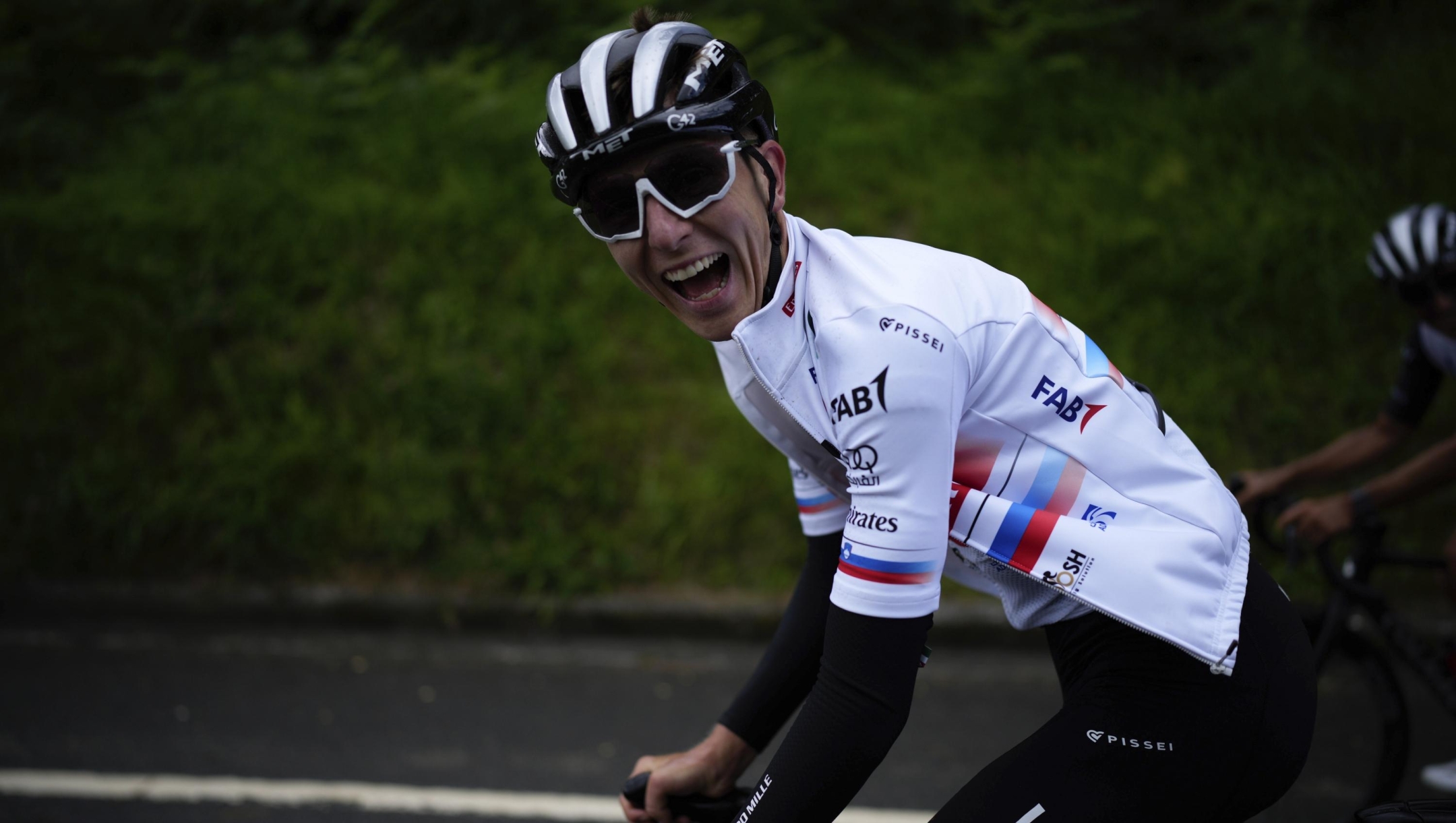 Slovenia's Tadej Pogacar laughs as he rides during a training session, in Bilbao, Spain, Friday, June 30, 2023. The Tour de France cycling race starts on Saturday, July 1, with the first stage over 182 kilometers (113 miles) with start and finish in Bilbao. (AP Photo/Daniel Cole)