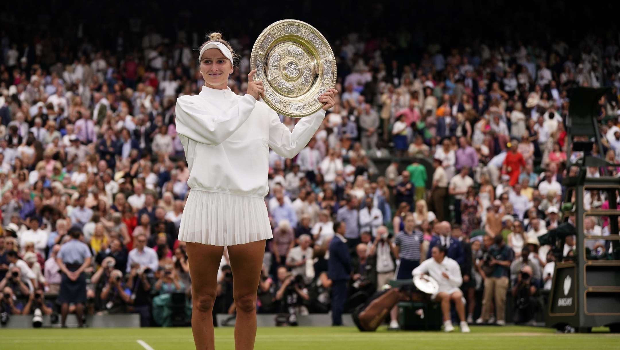 Czech Republic's Marketa Vondrousova celebrates with the trophy after beating Tunisia's Ons Jabeur to win the final of the women's singles on day thirteen of the Wimbledon tennis championships in London, Saturday, July 15, 2023. (AP Photo/Alberto Pezzali)
