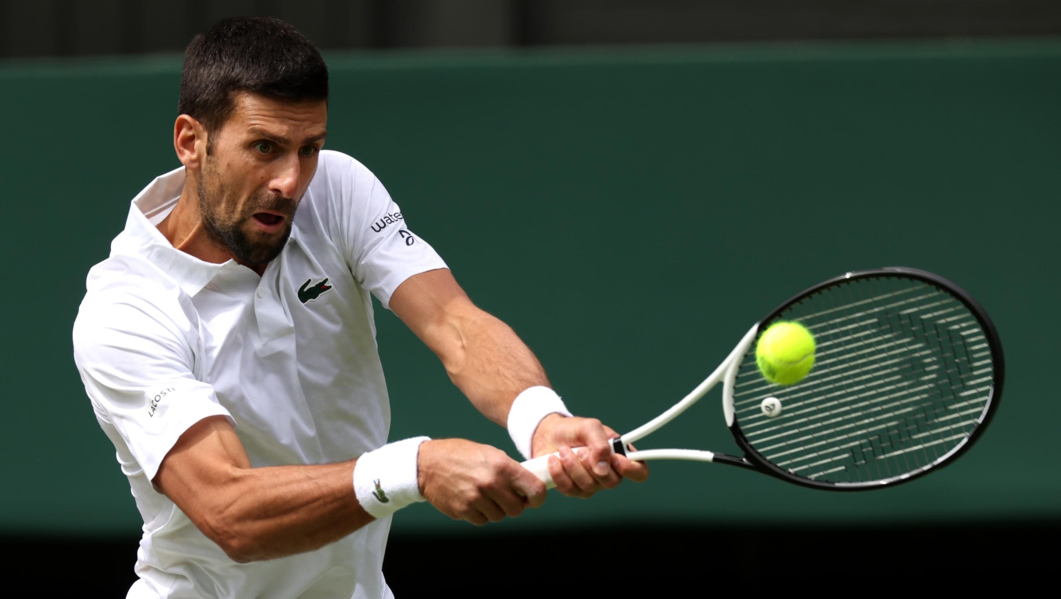 LONDON, ENGLAND - JULY 16: Novak Djokovic of Serbia plays a backhand in the Men's Singles Final against Carlos Alcaraz of Spain on day fourteen of The Championships Wimbledon 2023 at All England Lawn Tennis and Croquet Club on July 16, 2023 in London, England. (Photo by Clive Brunskill/Getty Images)