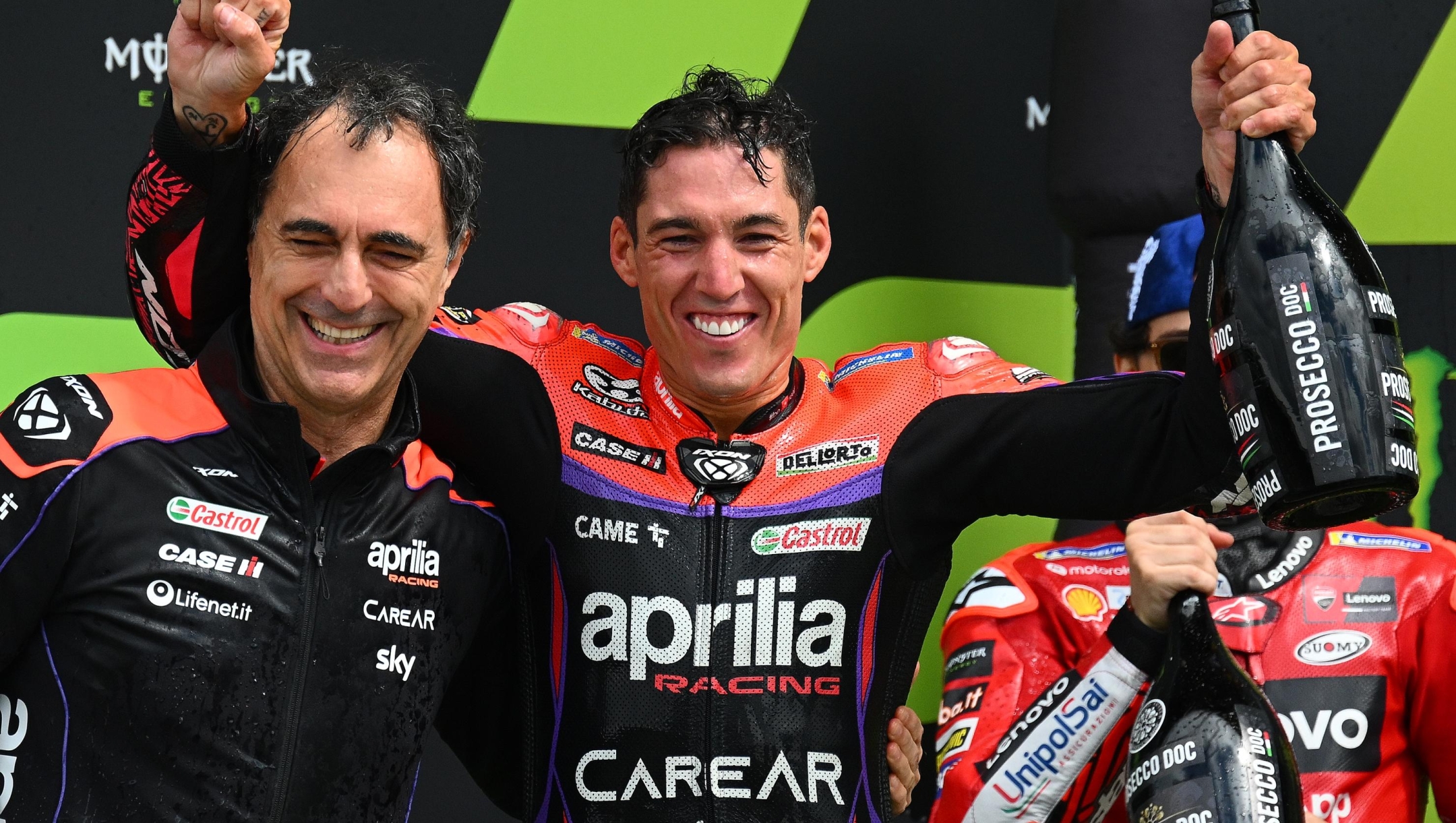 NORTHAMPTON, ENGLAND - AUGUST 06: Aleix Espargaro of Spain celebrates his win on the podium with Romano Albesiano, Technical director, Aprilia Racing Team after the MotoGP of Great Britain - Race at Silverstone Circuit on August 06, 2023 in Northampton, England. (Photo by Clive Mason/Getty Images)