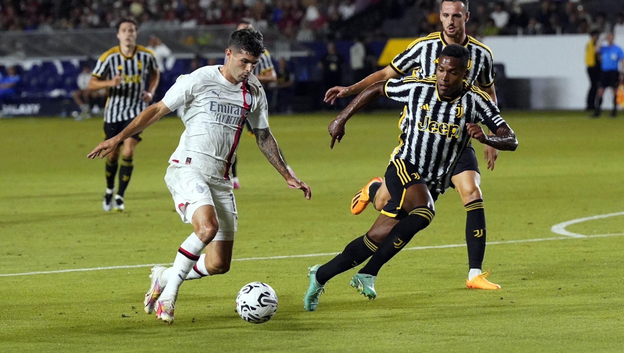 CARSON, CALIFORNIA - JULY 27: Christian Pulisic #11 of AC Milan controls the ball against Alex Sandro #12 of Juventus during the second half of the pre-season friendly match at Dignity Health Sports Park on July 27, 2023 in Carson, California.   Kevork Djansezian/Getty Images/AFP (Photo by KEVORK DJANSEZIAN / GETTY IMAGES NORTH AMERICA / Getty Images via AFP)