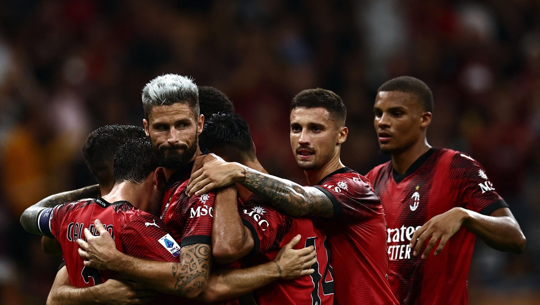 AC Milan's French forward Olivier Giroud (2ndL) celebrates with teammates after scoring during the Italian Serie A football match AC Milan vs Torino on August 26, 2023 at the San Siro Stadium in Milan. (Photo by MARCO BERTORELLO / AFP)