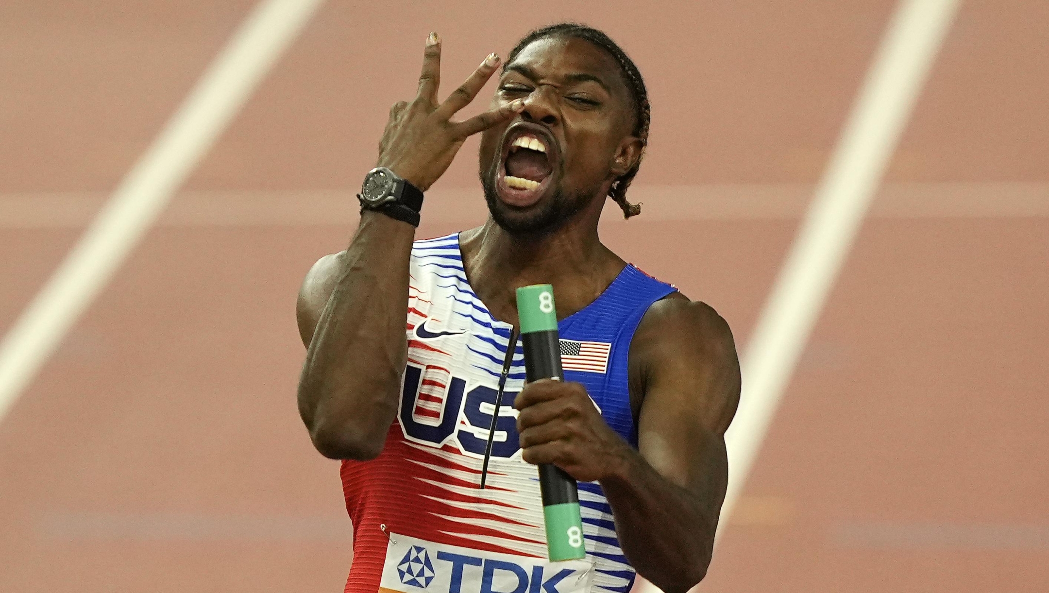 Noah Lyles, of the United States celebrates showing three fingers wanchoring his team to gold in the Men's 4x100-meters relay final during the World Athletics Championships in Budapest, Hungary, Saturday, Aug. 26, 2023. It is his third gold medal (AP Photo/Martin Meissner)