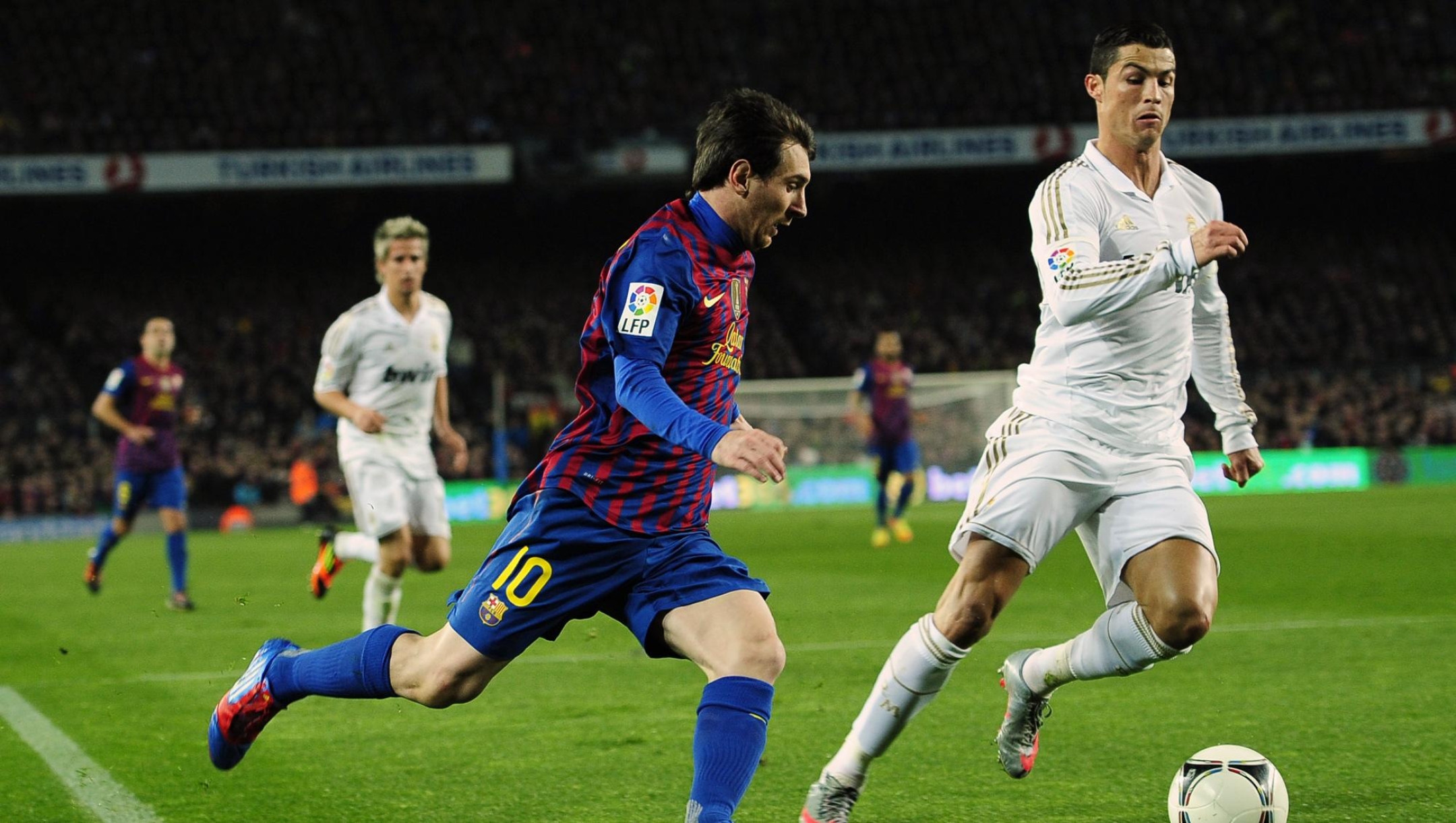 FILE -  FC Barcelona's Lionel Messi from Argentina, left, duels for the ball against Real Madrid's Cristiano Ronaldo, from Portugal, during their quarterfinal, second leg, Copa del Rey soccer match at the Camp Nou stadium, in Barcelona, Spain, Wednesday, Jan. 25, 2012. Cristiano Ronaldo, one of soccer's greatest ever players, was official unveiled for Saudi Arabian team Al Nassr on Tuesday, Jan. 3, 2023. Ronaldo, who has won five Ballon d'Ors awards and five Champions League titles, spent the past two decades at the top level of the European game, playing at three of the biggest clubs in the world: Manchester United, Real Madrid and Juventus. (AP Photo/Manu Fernandez, File)