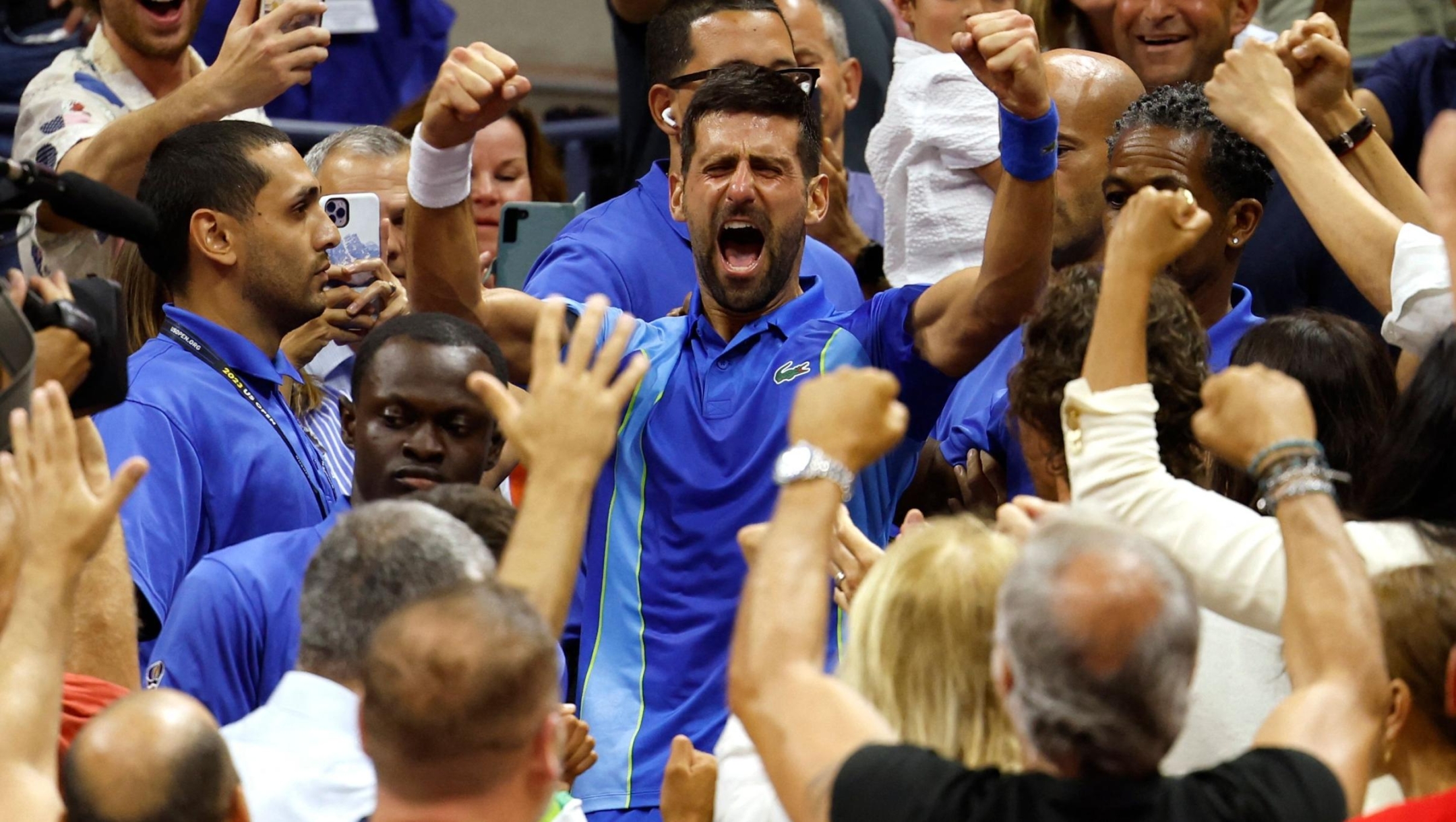 TOPSHOT - Serbia's Novak Djokovic celebrates with his team after defeating Russia's Daniil Medvedev during the US Open tennis tournament men's singles final match at the USTA Billie Jean King National Tennis Center in New York City, on September 10, 2023. (Photo by kena betancur / AFP)