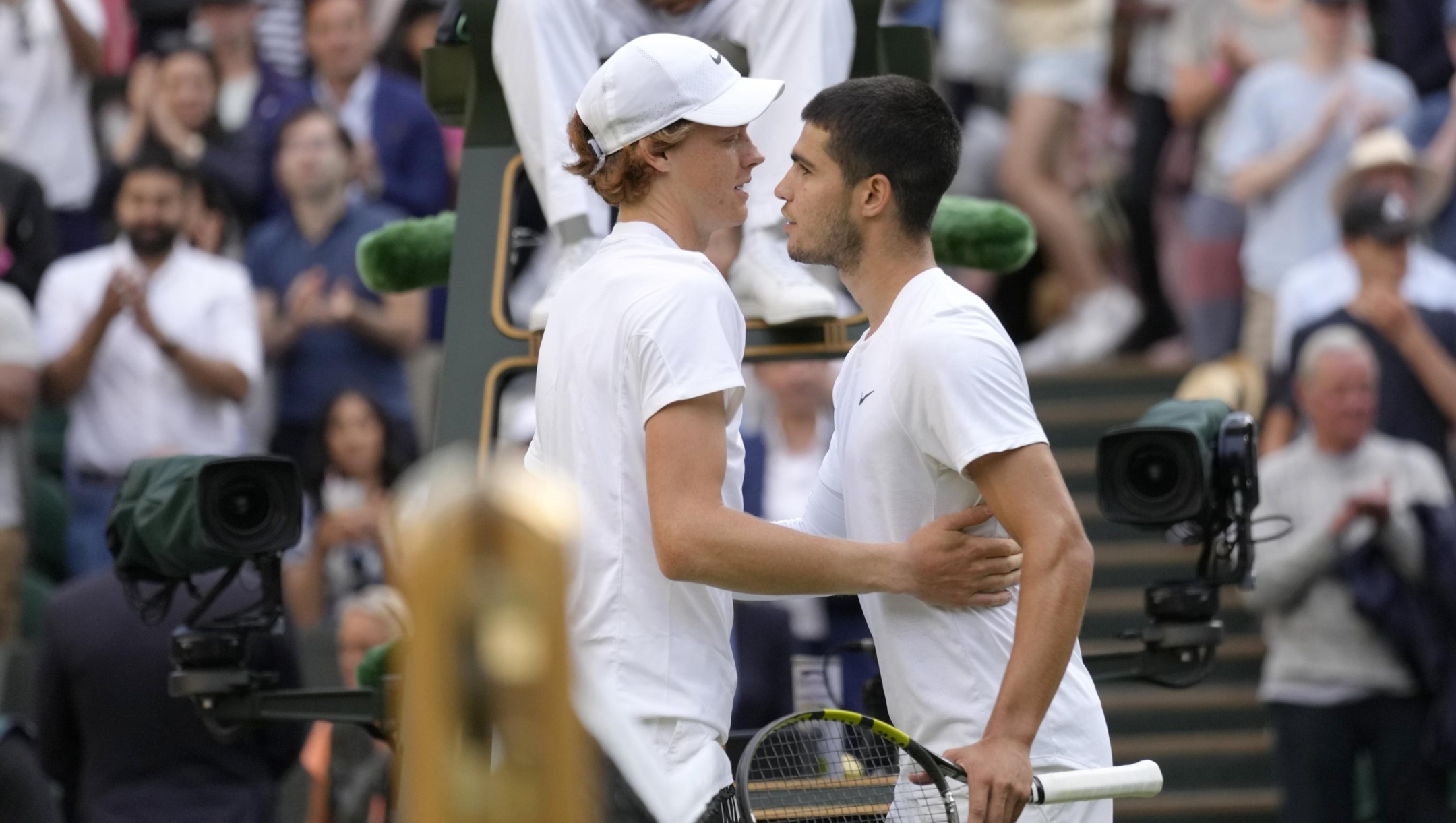 Italy's Jannik Sinner hugs Spain's Carlos Alcaraz after defeating him a men's fourth round singles match on day seven of the Wimbledon tennis championships in London, Sunday, July 3, 2022.(AP Photo/Kirsty Wigglesworth)